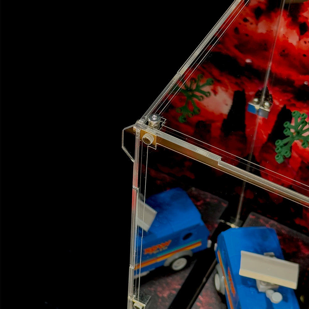 Close-up of the acrylic display case corner showing transparent panels and connecting hardware