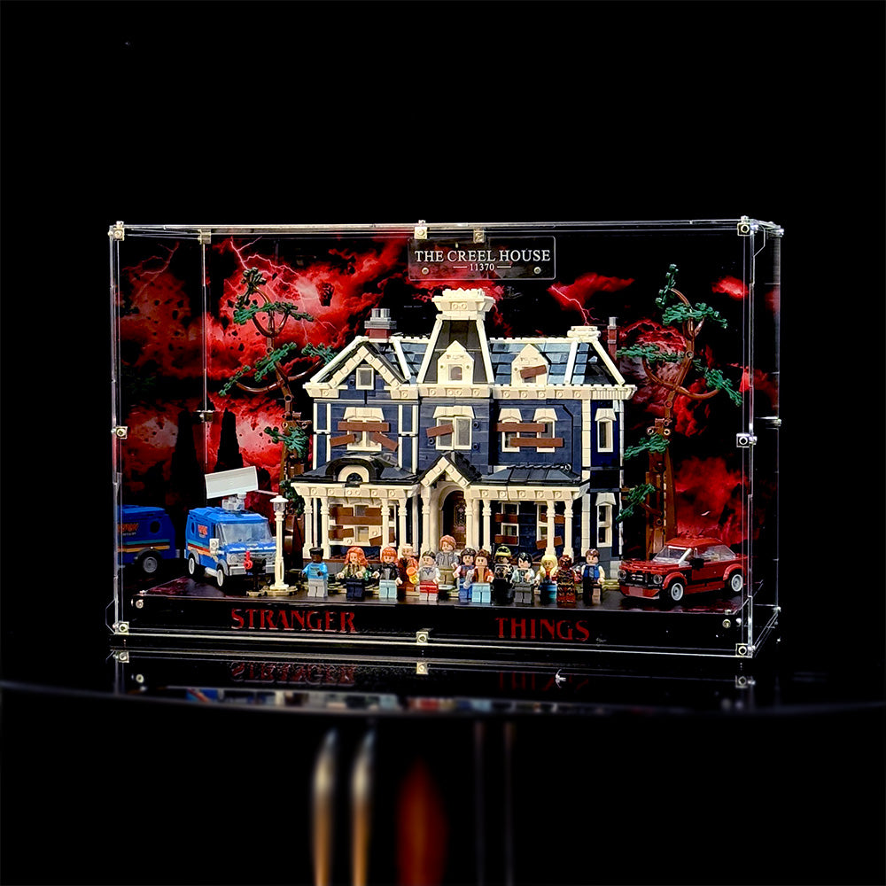 Full view of the acrylic display case with the Creel House 11370 model shown against the red-and-black scenic background