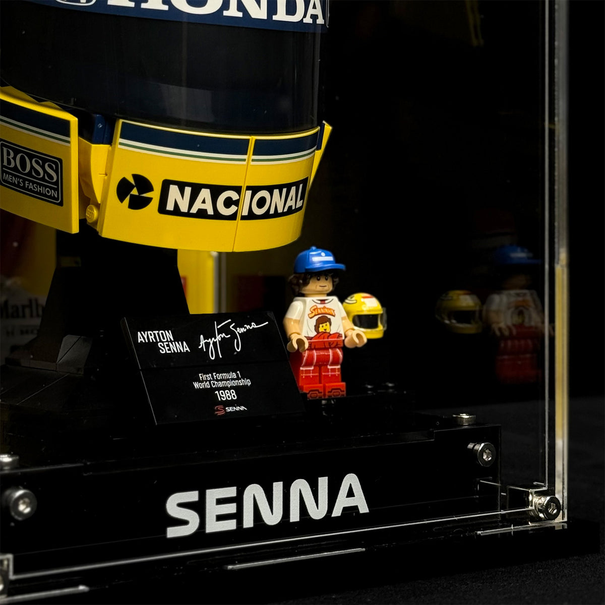Close-up of the SENNA front panel with the helmet model and minifigure shown for illustration